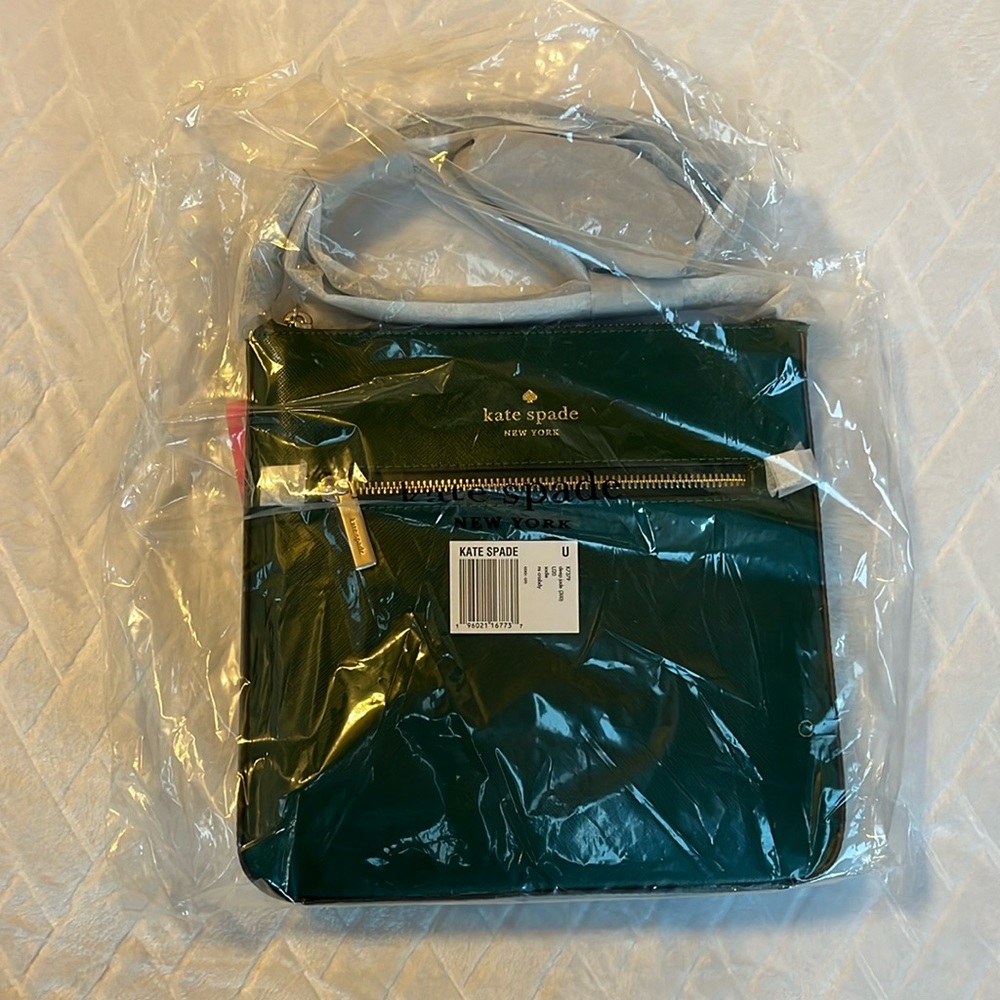 Green Kate Spade purse, brand new with tags and packaging, small blemish.